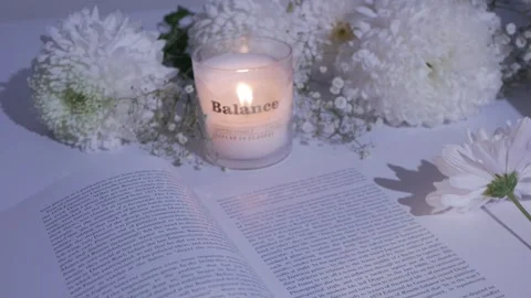 Close-up white flowers on an open book.burning candle. chrysanthemum. gypsophila Stock Footage 260417754