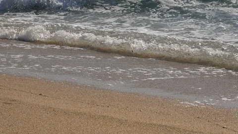 Close up of white foaming waves lapping on the sandy beach Stock Footage 103627137
