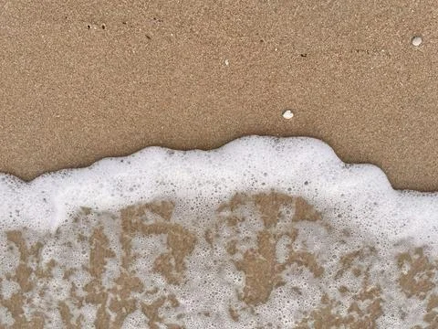 Close-up of white foamy waves on a sandy beach (3) Stock Photos