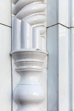 Close-up of a white glazed ceramic architectural column showing ornate moldin Stock Photos