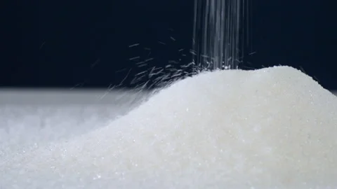Close-up of white granulated sugar falling on a blue background Stock Footage 178448696