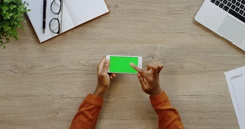 Close up of the white horizontal smartphone being on the light wooden desk of Stock Footage 96005299