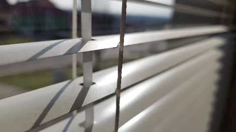 Close-up of white horizontal window blinds with sun rays and shadows Vídeos de archivo 333642780