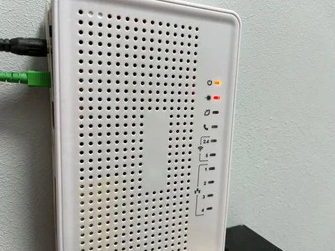Close-up of a white internet router on a white wall. Stock Photos