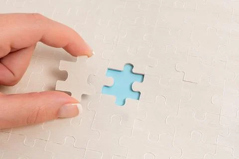 Close-Up White Jigsaw Pattern Puzzle Pieces To Be Connected With Missing Last Foto stock