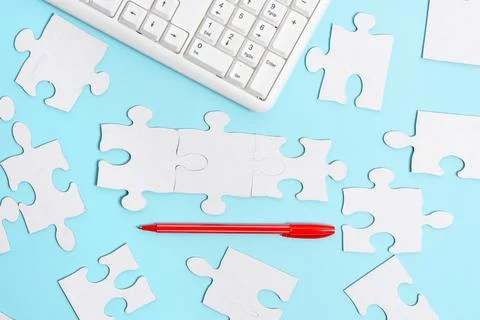 Close-Up White Jigsaw Pattern Puzzle Pieces To Be Connected With Missing Last Foto stock