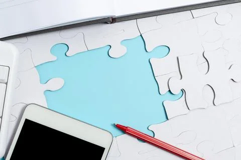Close-Up White Jigsaw Pattern Puzzle Pieces To Be Connected With Missing Last Foto stock
