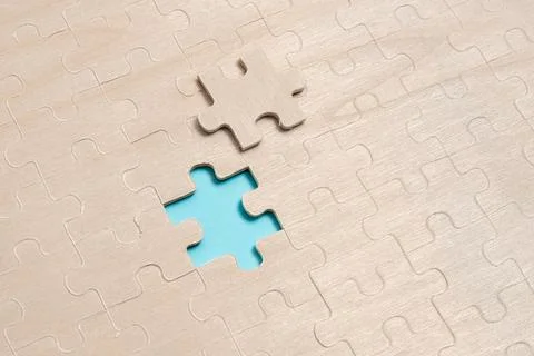 Close-Up White Jigsaw Pattern Puzzle Pieces To Be Connected With Missing Last Stock Photos