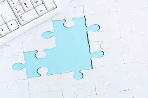 Close-Up White Jigsaw Pattern Puzzle Pieces To Be Connected With Missing Last Stock Photos