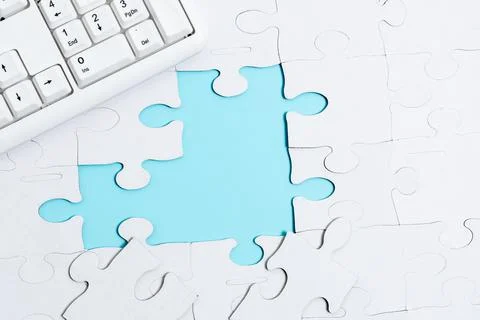 Close-Up White Jigsaw Pattern Puzzle Pieces To Be Connected With Missing Last Stock Photos