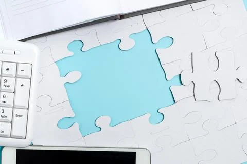 Close-Up White Jigsaw Pattern Puzzle Pieces To Be Connected With Missing Last Stock Photos