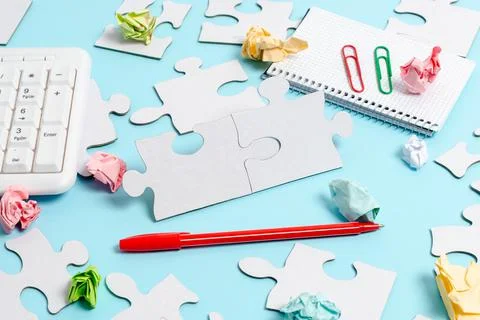 Close-Up White Jigsaw Pattern Puzzle Pieces To Be Connected With Missing Last Stock Photos