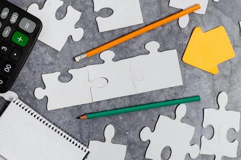 Close-Up White Jigsaw Pattern Puzzle Pieces To Be Connected With Missing Last Stock Photos