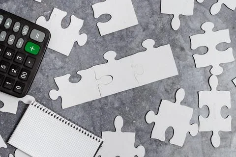 Close-Up White Jigsaw Pattern Puzzle Pieces To Be Connected With Missing Last Stock Photos