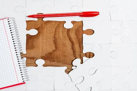 Close-Up White Jigsaw Pattern Puzzle Pieces To Be Connected With Missing Last Stock Photos