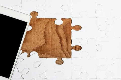 Close-Up White Jigsaw Pattern Puzzle Pieces To Be Connected With Missing Last Stock Photos
