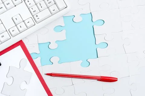 Close-Up White Jigsaw Pattern Puzzle Pieces To Be Connected With Missing Last Stock Photos