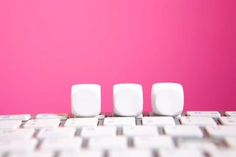 Close up of white keys on a computer keyboard with pink background. Stock Photos