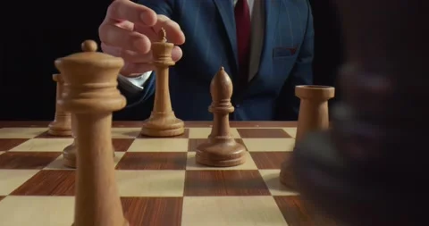 Close-up white king chess piece defeated enemy by checkmate at end of chessboard Stock Footage 135658782