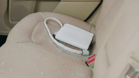 Close-up of a white lady's bag on the back seat of a car. Leather interior of a Stock Footage 276262449