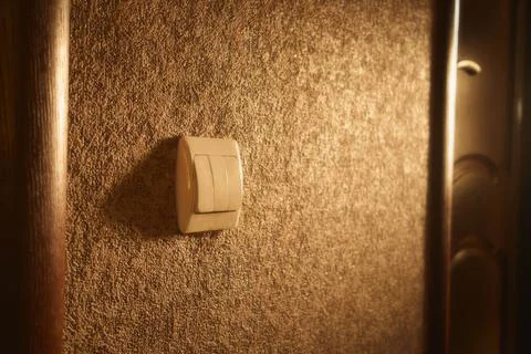Close-up of a white light switch in sunlight Stock Photos