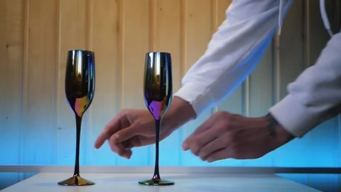 Close up of white male hands serving the table with fancy glasses and a bottle Vidéo 197079511