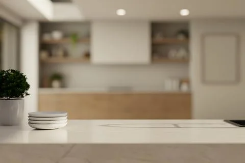 Close up of white marble counter with stacked plates and small green plant .. Stock Illustration