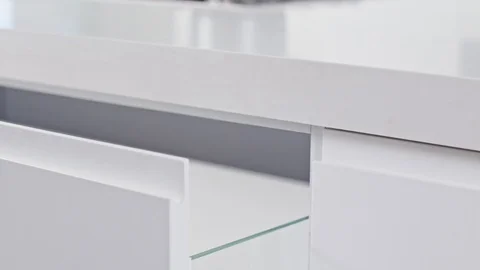 Close up of a white modern luxury kitchen drawer closing slowly Stock Footage 112107599
