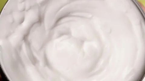 Close-up of white moisturizer for face and body, showcasing the smooth Stock Footage 299940247