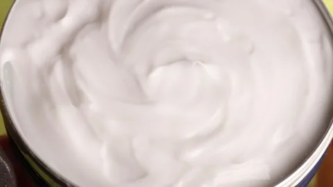 Close-up of white moisturizer for face and body, showcasing the smooth Stock Footage 299940346