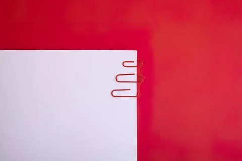 Close-up of white notebook with red paper clips on red background Stock Photos
