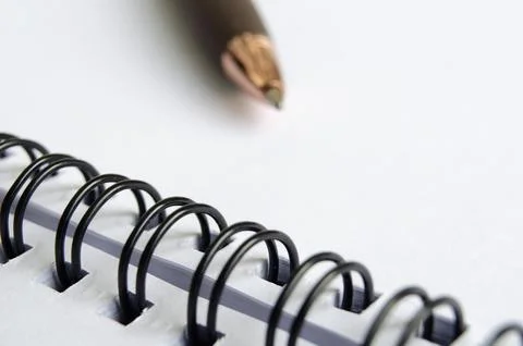 Close up of white notepad with blur pen background Stock Photos