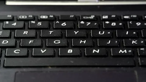 Close-up of white numbers and letters on the keys of a black laptop keyboard Stock Footage 342255844