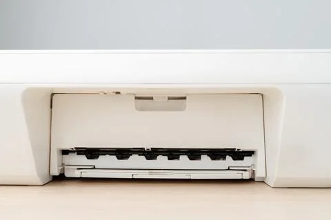 Close-Up Of White Office Printer Paper Tray And Output Slot On Wooden Desk .. Stock Photos