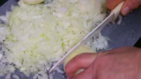 Close-up of white onion. The cook cuts the onion into rings; the onion lies in Video stock 296126413