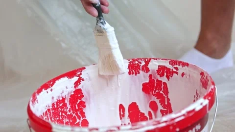 Close up of white paint dripping from a brush, process of preparing to paint Stock Footage 249283416