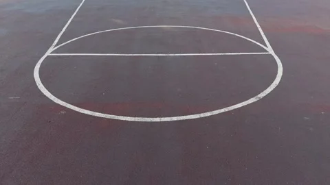 Close-up of white painted lines on a dark textured asphalt basketball court Vídeos de archivo 340261388