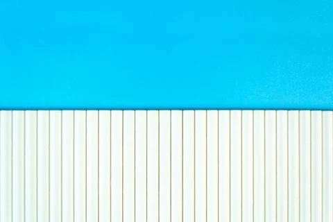 Close up white paper straw pattern on blue background. Flat lay cocktail tube Stock Photos