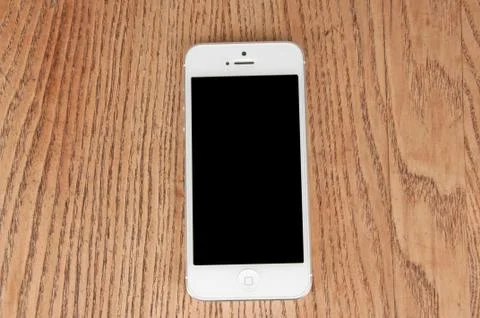 Close-up white phone on the table Stock Photos