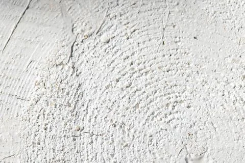 Close-up of a white plaster wall showing rough painted log texture Stock Photos