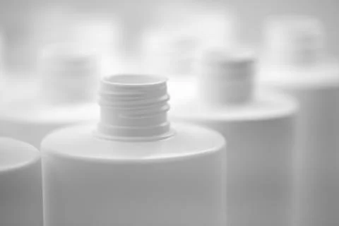 Close up of a white plastic bottle, plastic packaging industry concept backgr Foto stock