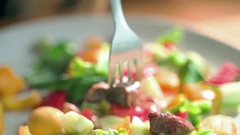 A close-up of a white plate on which a fork stirs fresh lard. Video stock 234022834