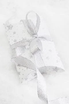 Close up of white present box with silver ribbon for christmas on white backg Stock Photos
