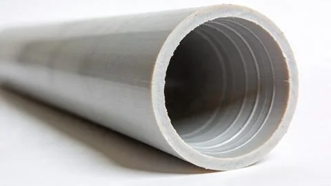 Close-up of white PVC pipe with internal threading. Detail of plastic plumbing c Stock Photos