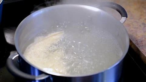 Close Up of White Rice Boiling in Pot on Kitchen Stove Stock Footage 332319043
