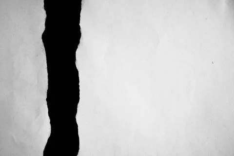 Close up of a white ripped or torn piece of paper with copy space. Foto stock