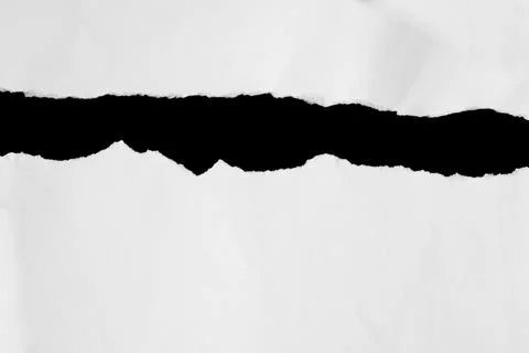 Close up of a white ripped or torn piece of paper with copy space. Stock Photos