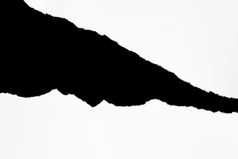 Close up of a white ripped or torn piece of paper with copy space. Stock Photos