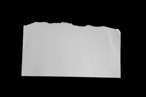 Close up of a white ripped or torn piece of paper with copy space. Stock Photos