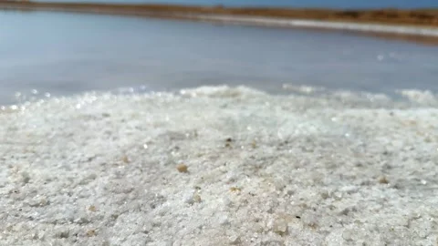 Close Up of White Salt Crystal Crust Deposits on the Shore of Saline Lake in Ras 動画素材 341838097
